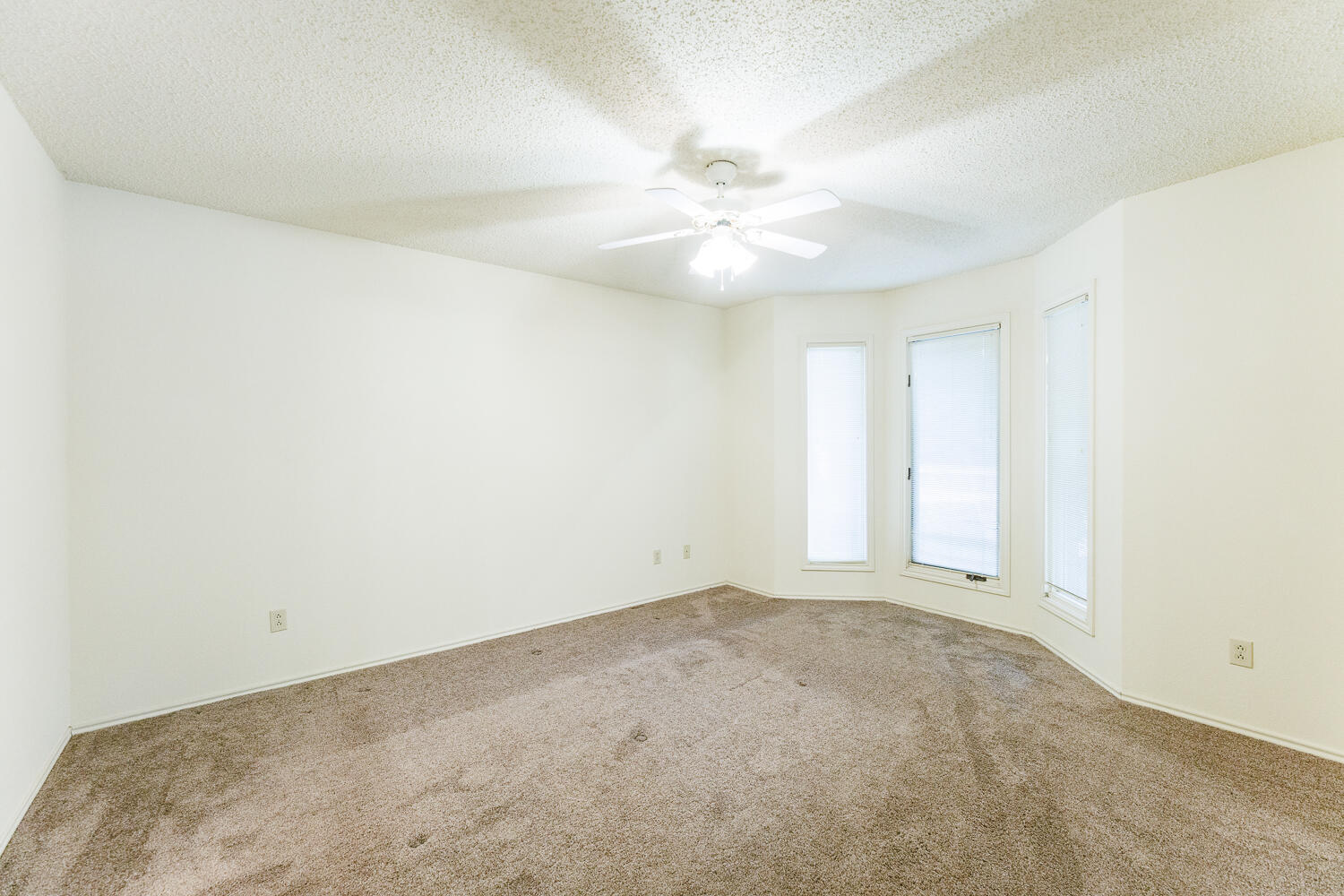 7610 Utica Avenue Lubbock, TX 79424 - Photo 39 of 49 an empty room with a window and a fan