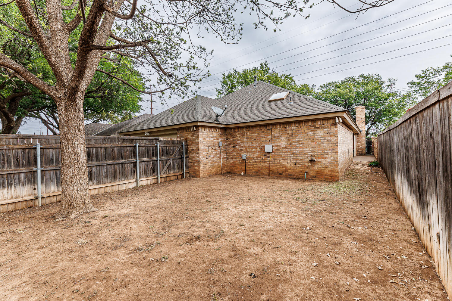 7610 Utica Avenue Lubbock, TX 79424 - Photo 45 of 49 a front view of a house with a tree