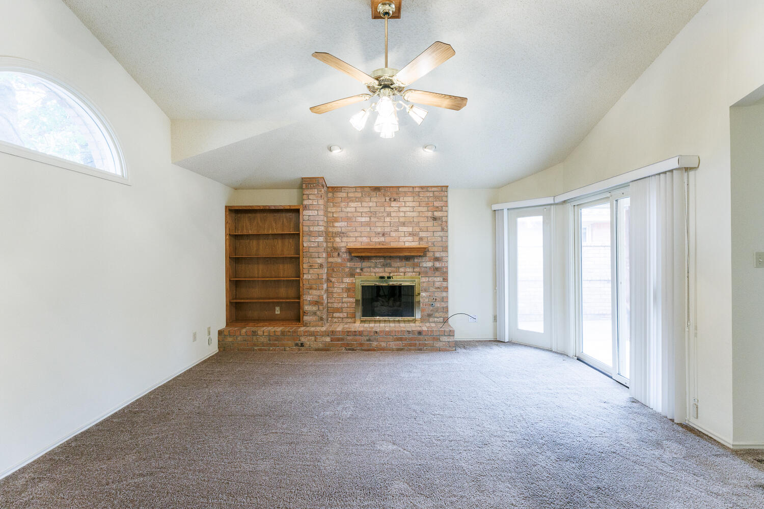 7610 Utica Avenue Lubbock, TX 79424 - Photo 7 of 49 an empty room with windows and fireplace