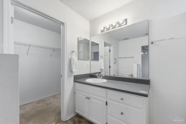 a bathroom with a granite countertop sink mirror and vanity
