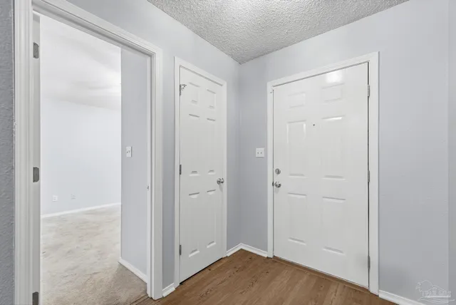 an empty room with closet and wooden floor