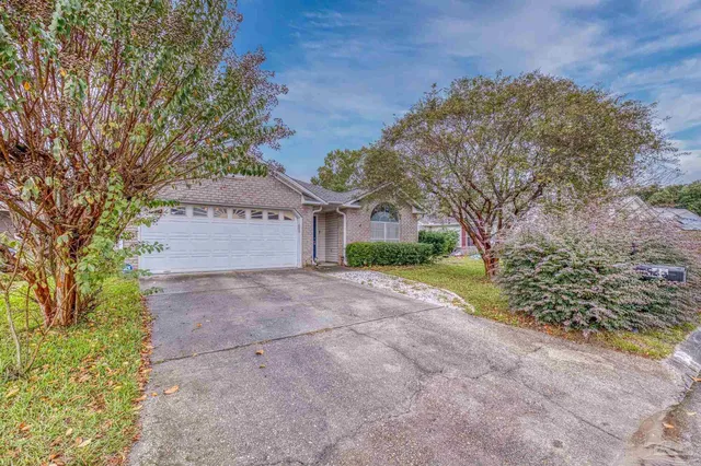 a view of a house with a yard and tree