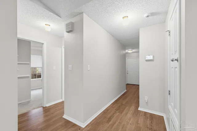 a view of hallway with wooden floor