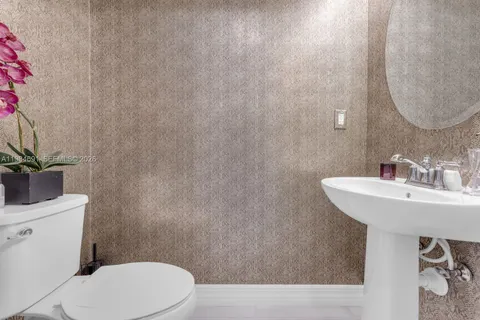 a view of a dining room with furniture and a mirror