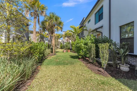a front view of a house with yard and parking