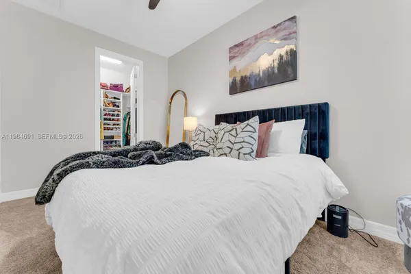 a bed room with a bed and a painting