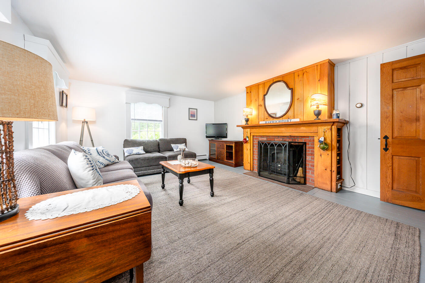 264 Route 28 Harwich, MA 02646 - Photo 11 of 39 a living room with furniture a fireplace and a wooden floor