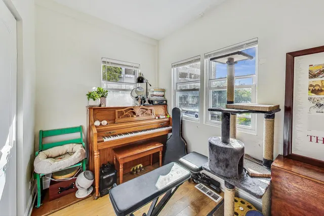 a living room with furniture a window and a flat screen tv