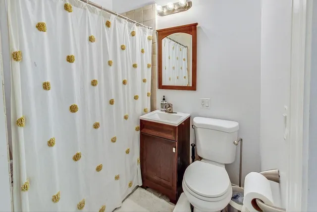 a white toilet sitting next to a bathroom sink