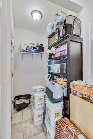 a kitchen with a refrigerator and a stove top oven