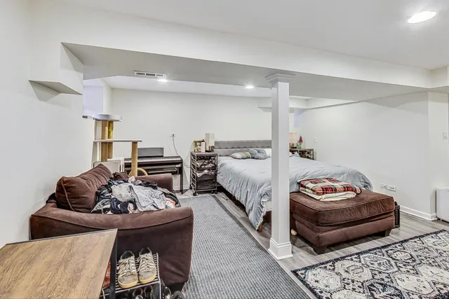 a bedroom with bed and a couch