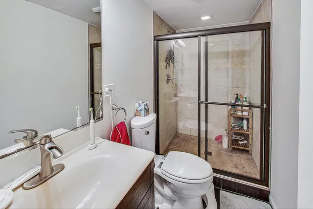 a bathroom with a sink toilet and shower