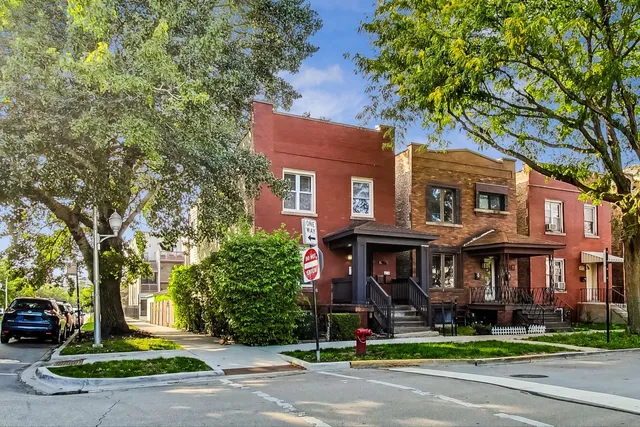 a front view of a brick house with a yard