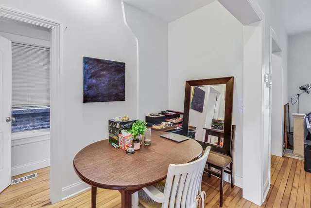a dining room with furniture and wooden floor