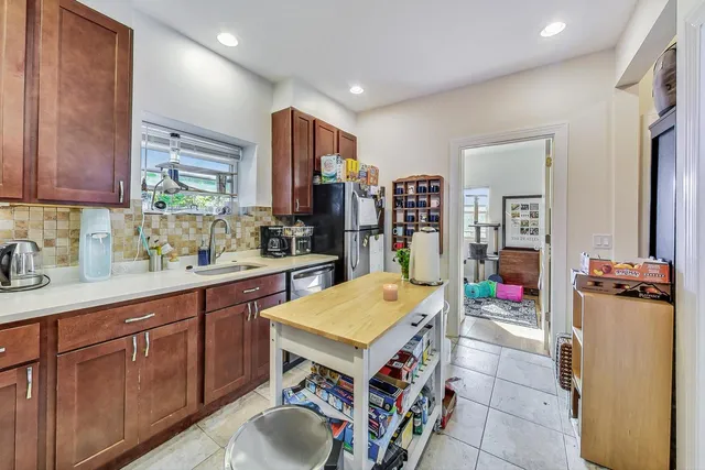 a kitchen with refrigerator and washer