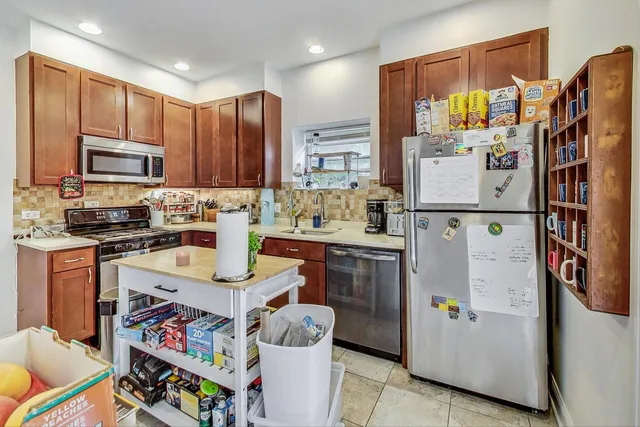 a kitchen with refrigerator and cabinets