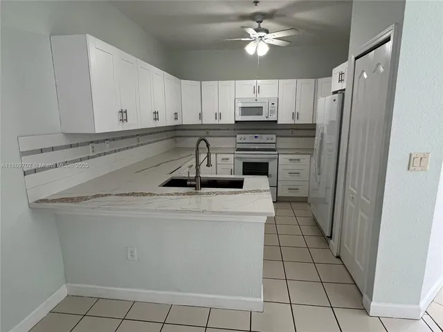 a kitchen with cabinets and steel stainless steel appliances