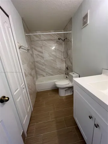 a utility room with a sink and a mirror