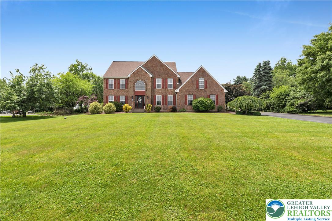 3830 McIntosh Drive Orefield, PA 18069 - Photo 1 of 36 a front view of a house with yard and green space