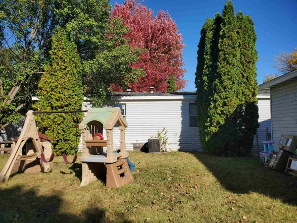 a view of a house with backyard sitting area and garden