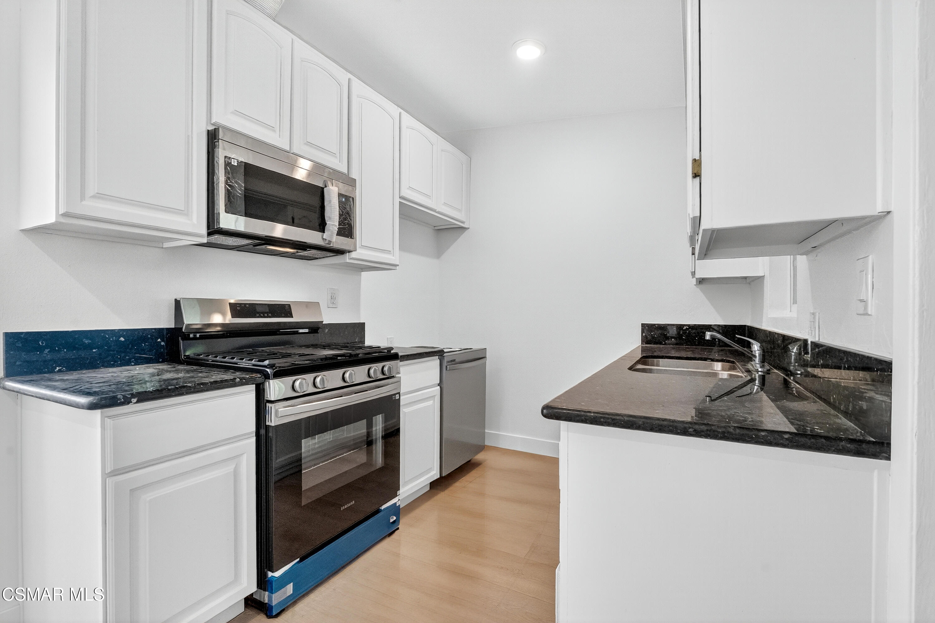 2251 Bryce Road El Monte, CA 91732 - Photo 1 of 16 a kitchen with stainless steel appliances granite countertop a sink stove and microwave