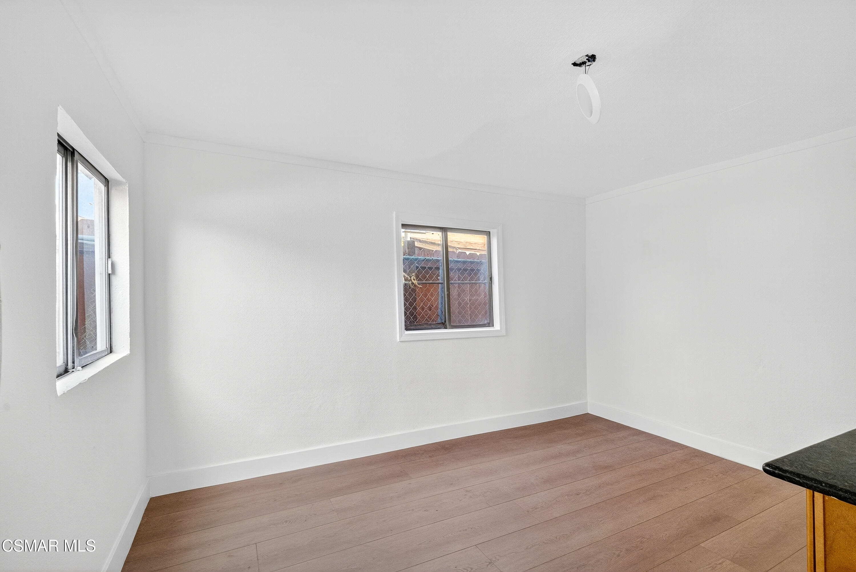 2251 Bryce Road El Monte, CA 91732 - Photo 13 of 16 a view of an empty room with wooden floor and a window
