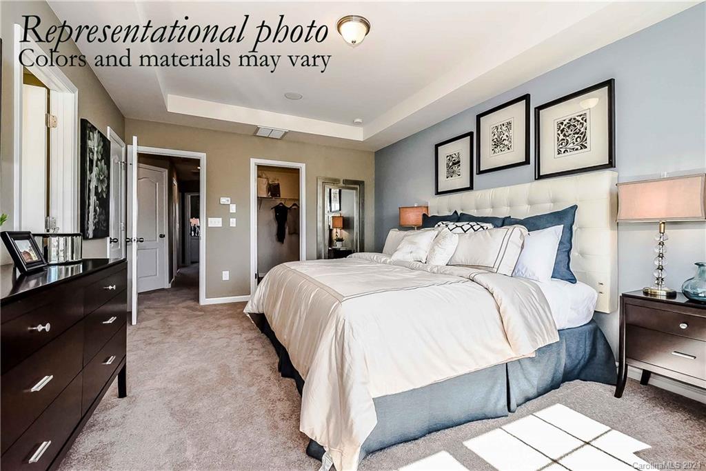 1653 Corwin Bend Road Tega Cay, SC 29708 - Photo 8 of 9 a spacious bedroom with a bed and a lamp