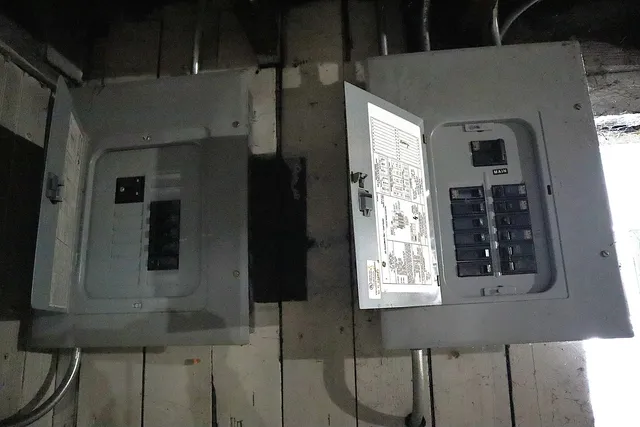 a view of a house with wooden deck stairs and furniture