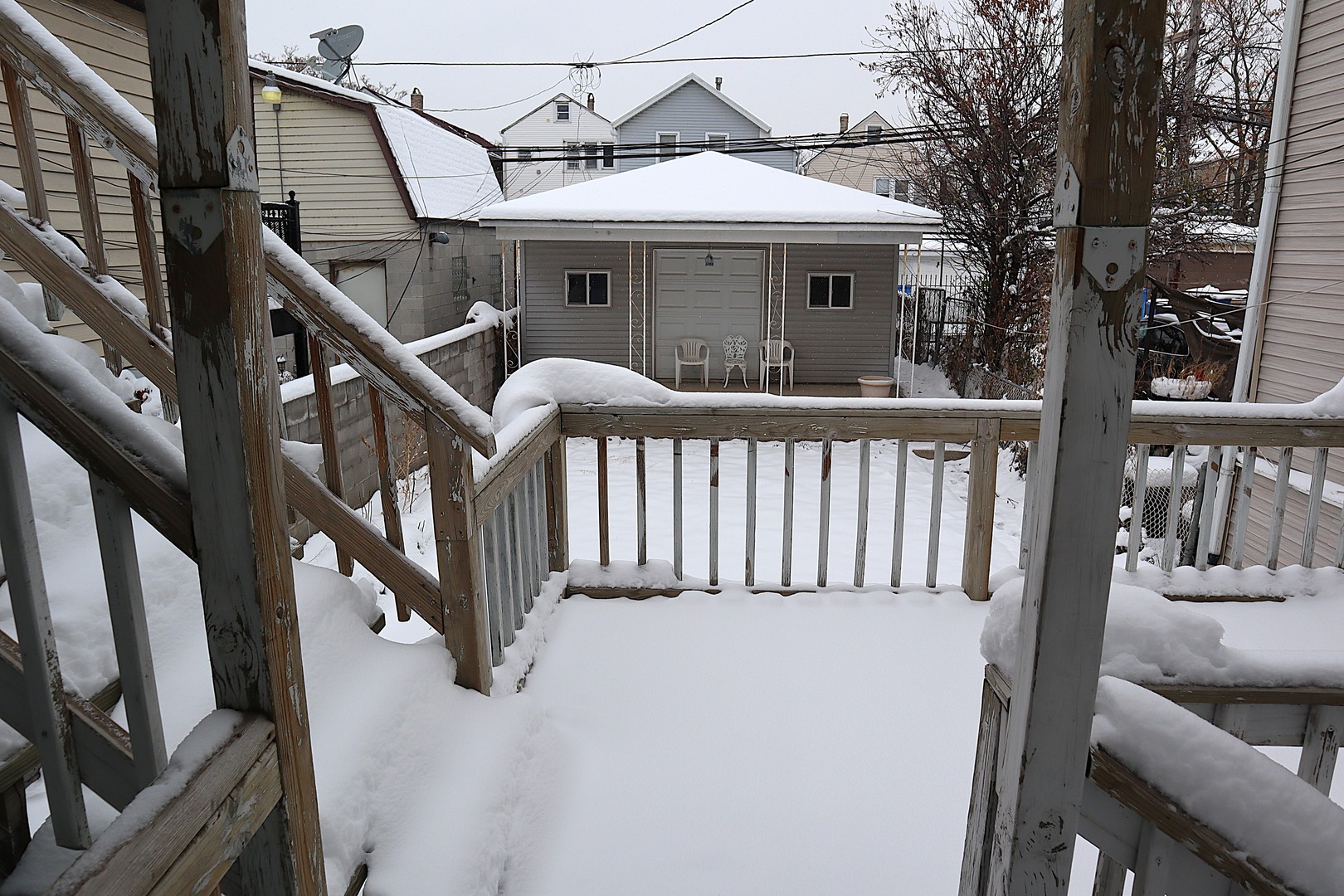 1934 West 21st Place Chicago, IL 60608 - Photo 16 of 25 a view of a house with wooden deck stairs and furniture