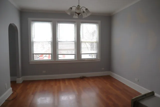 a view of room with window and wooden floor