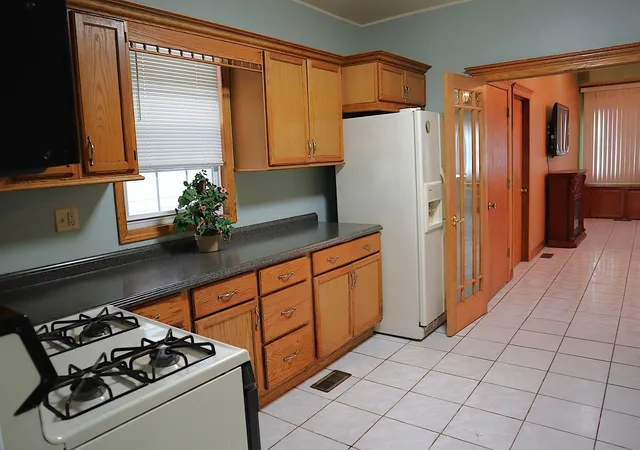 a kitchen with stainless steel appliances a refrigerator sink and cabinets