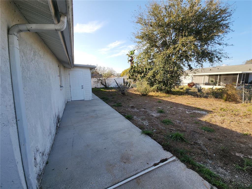7721 Foxbloom Drive Port Richey, FL 34668 - Photo 14 of 15 a view of a backyard of the house