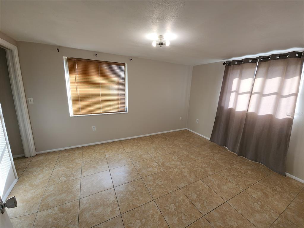 7721 Foxbloom Drive Port Richey, FL 34668 - Photo 7 of 15 an empty room with a window and closet