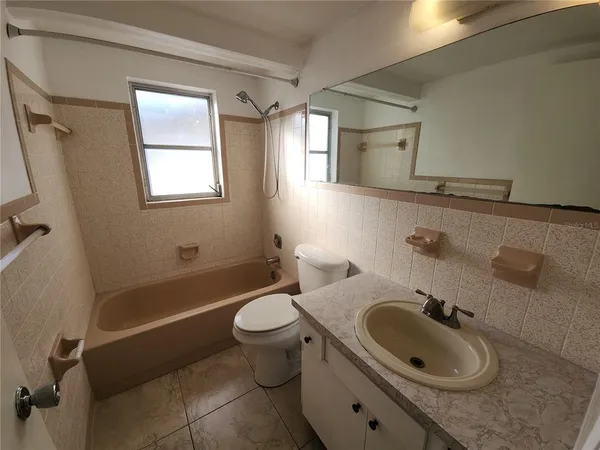 a bathroom with a sink a toilet and bathtub