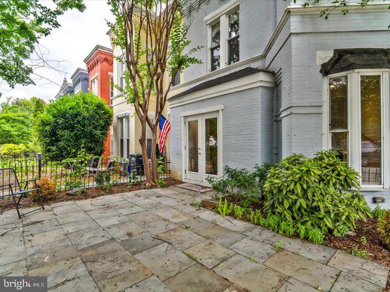 1200 D Street Northeast Washington, DC 20002 - Photo 41 of 47 Charming patio with lush greenery.