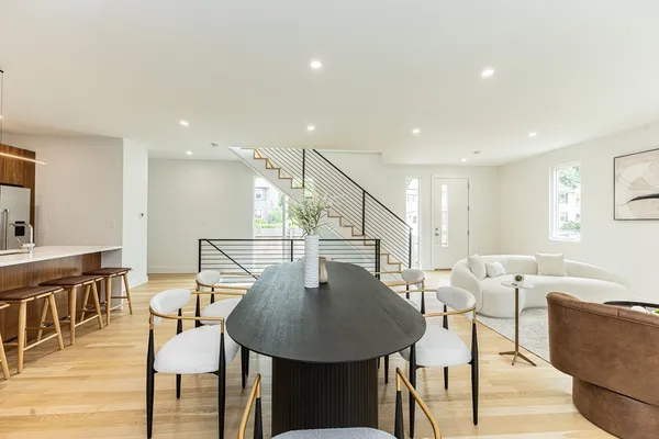 a view of a dining room with furniture and wooden floor