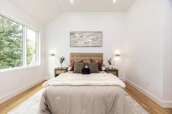 a bed sitting in a bedroom next to a window