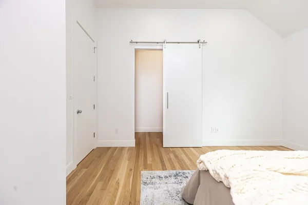 a view of a room with wooden floor