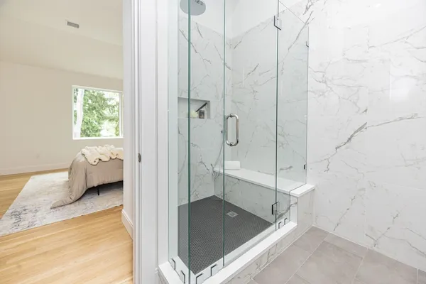 a bathroom with a tub shower and a sink
