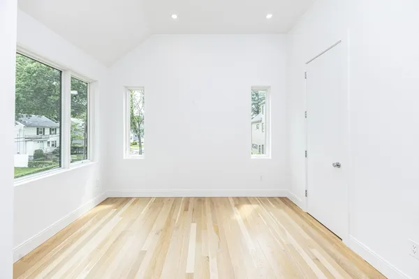 a view of room with window and hardwood floor