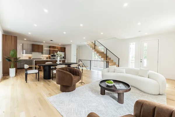 a living room with furniture and kitchen view