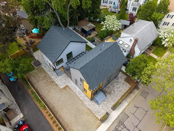 an aerial view of residential houses with outdoor space