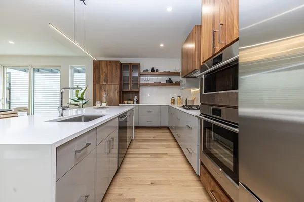 a kitchen with stainless steel appliances kitchen island granite countertop a sink and cabinets