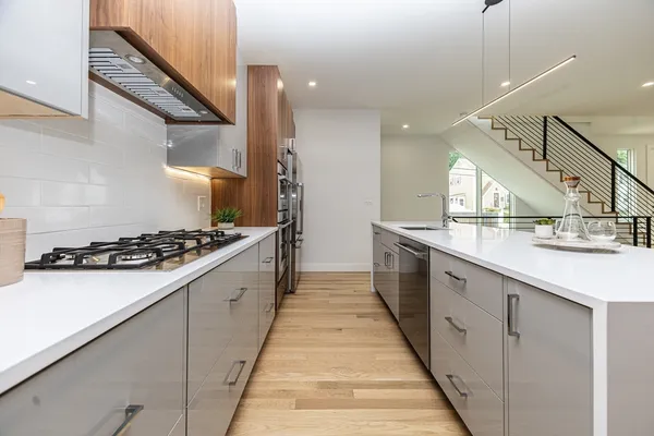 a large kitchen with stainless steel appliances a sink and a stove