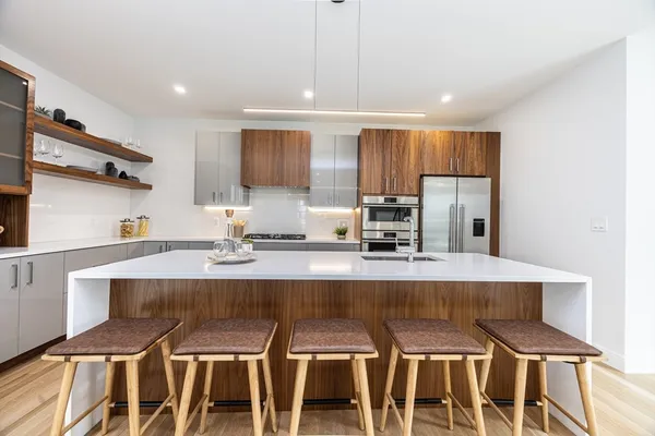 a kitchen with kitchen island granite countertop a table and chairs in it