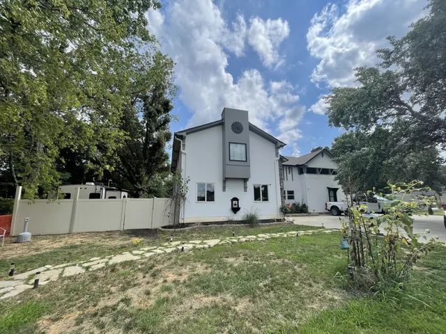 a large tree in front of a house