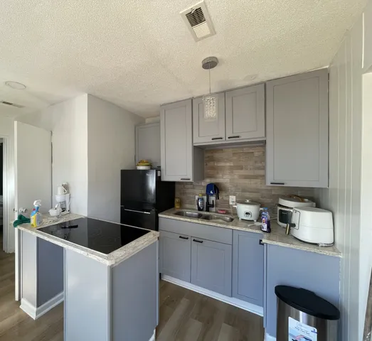 a bathroom with a shower and a sink