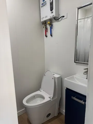 a bedroom with a bed and a mirror