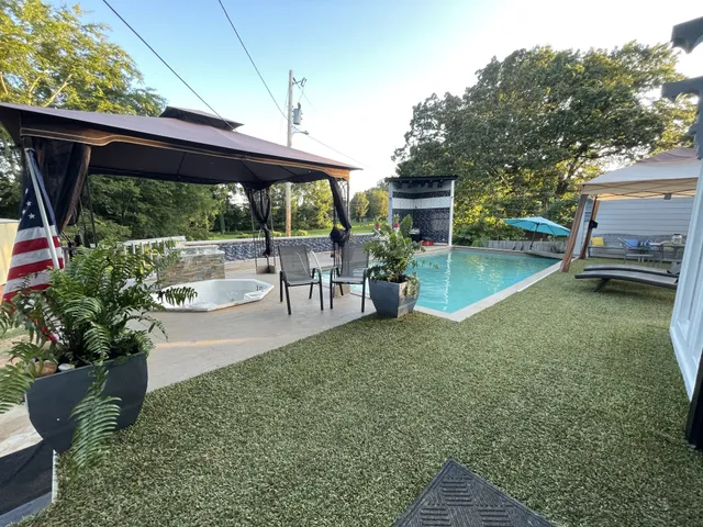 a view of a patio with table and chairs potted plants