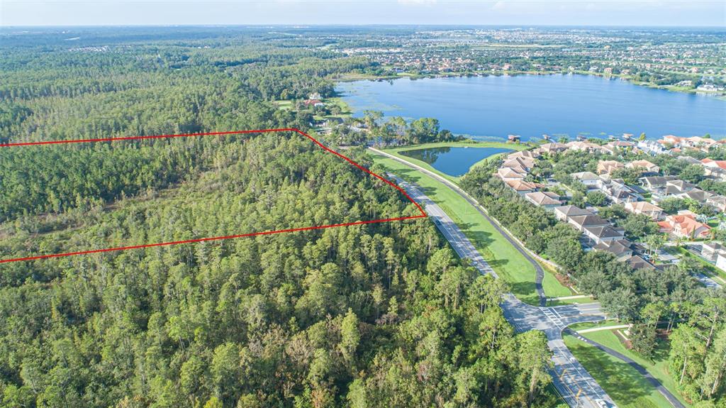 7545 Ficquette Road Windermere, FL 34786 - Photo 8 of 23 an aerial view of a houses with a lush green hillside